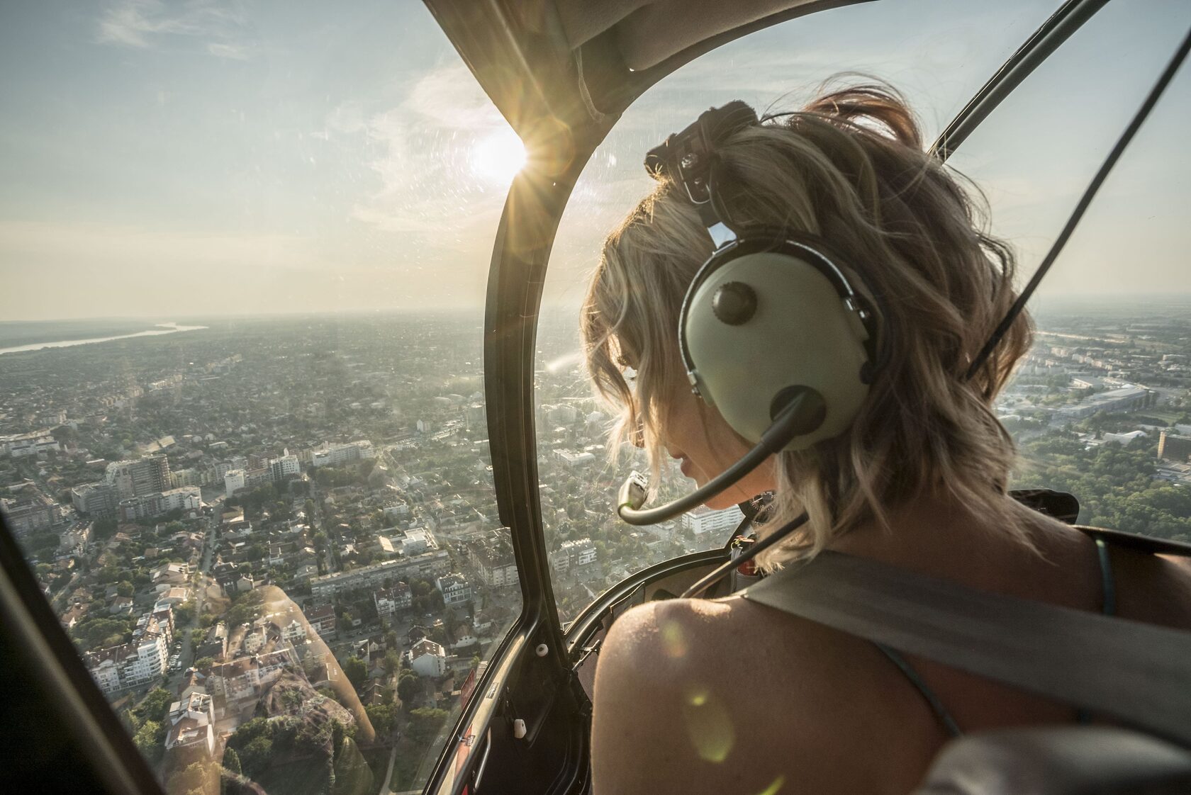 a woman in the helicopter above the city