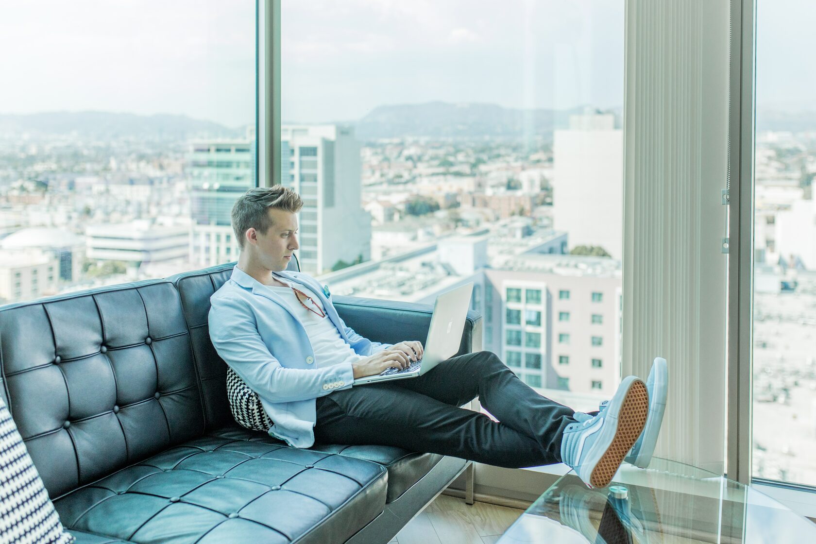 entrepreneur sitting on couch with his laptop