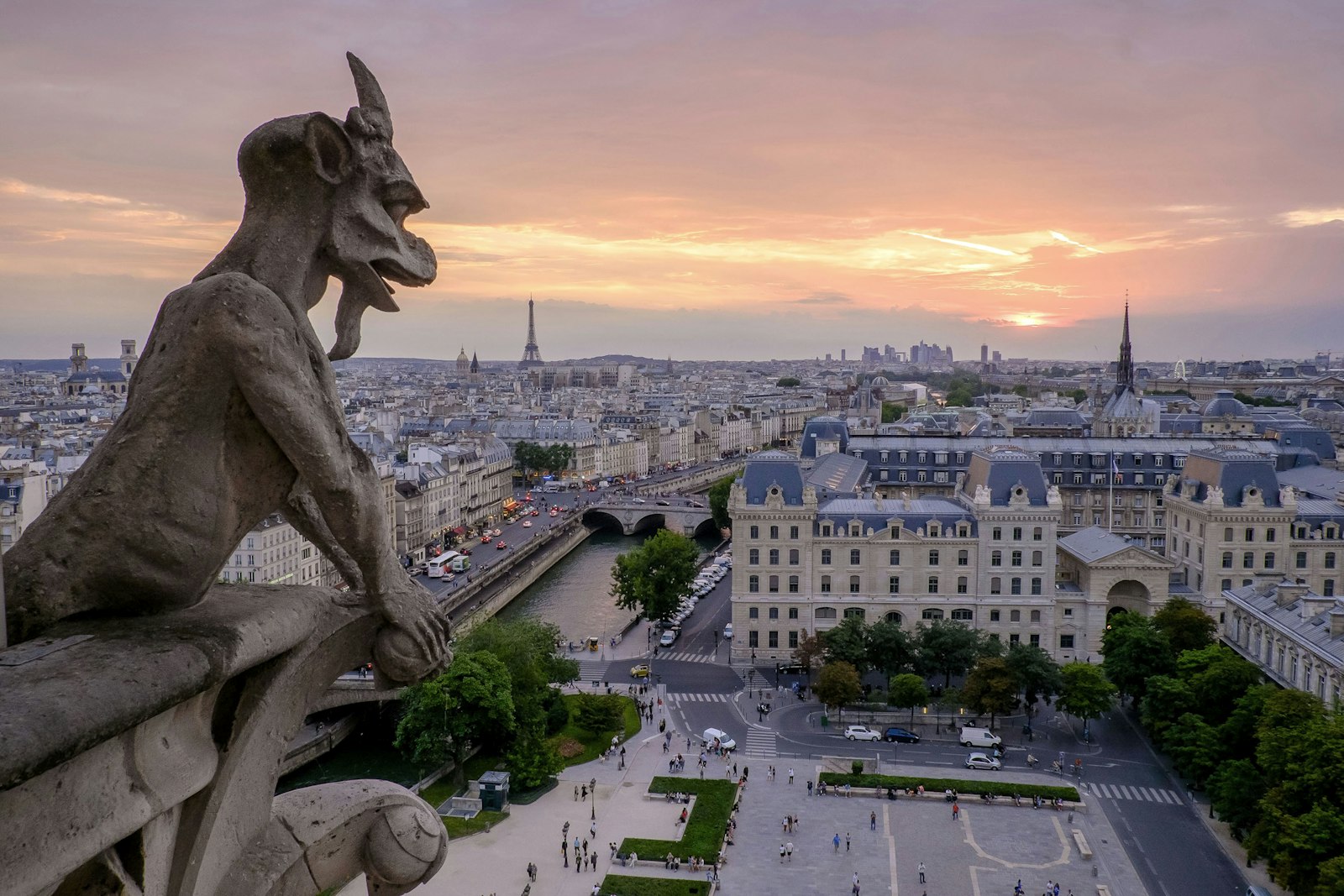 A chimera on Notre-Dame looking over Paris at sunrise