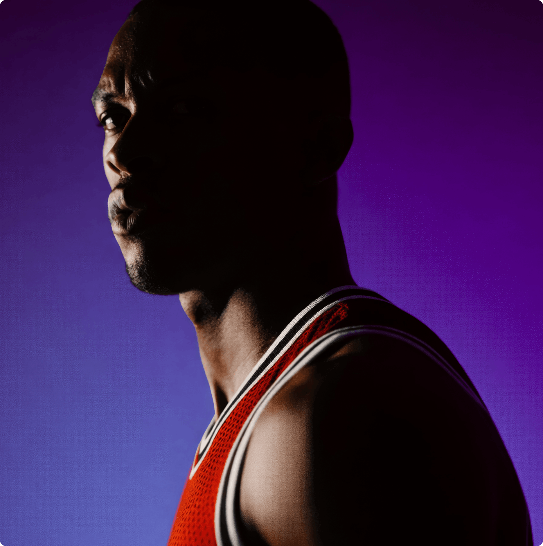 Айдентика Okko Sport: драматичный портрет спортсмена в красной баскетбольной майке на фиолетовом фоне, лицо частично в тени.