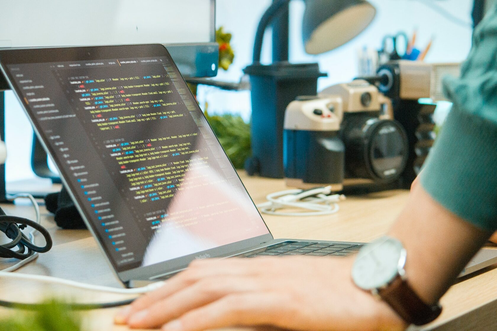 An image of a laptop with some code on the screen