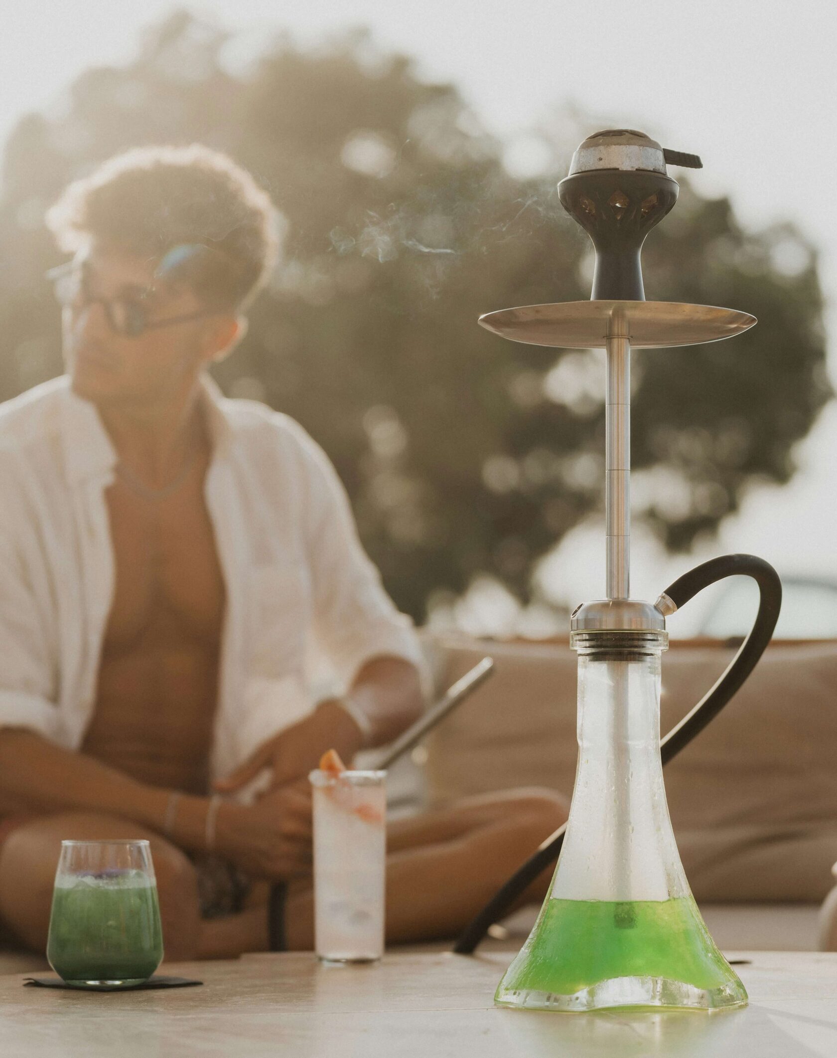 a man with shisha device on the beach