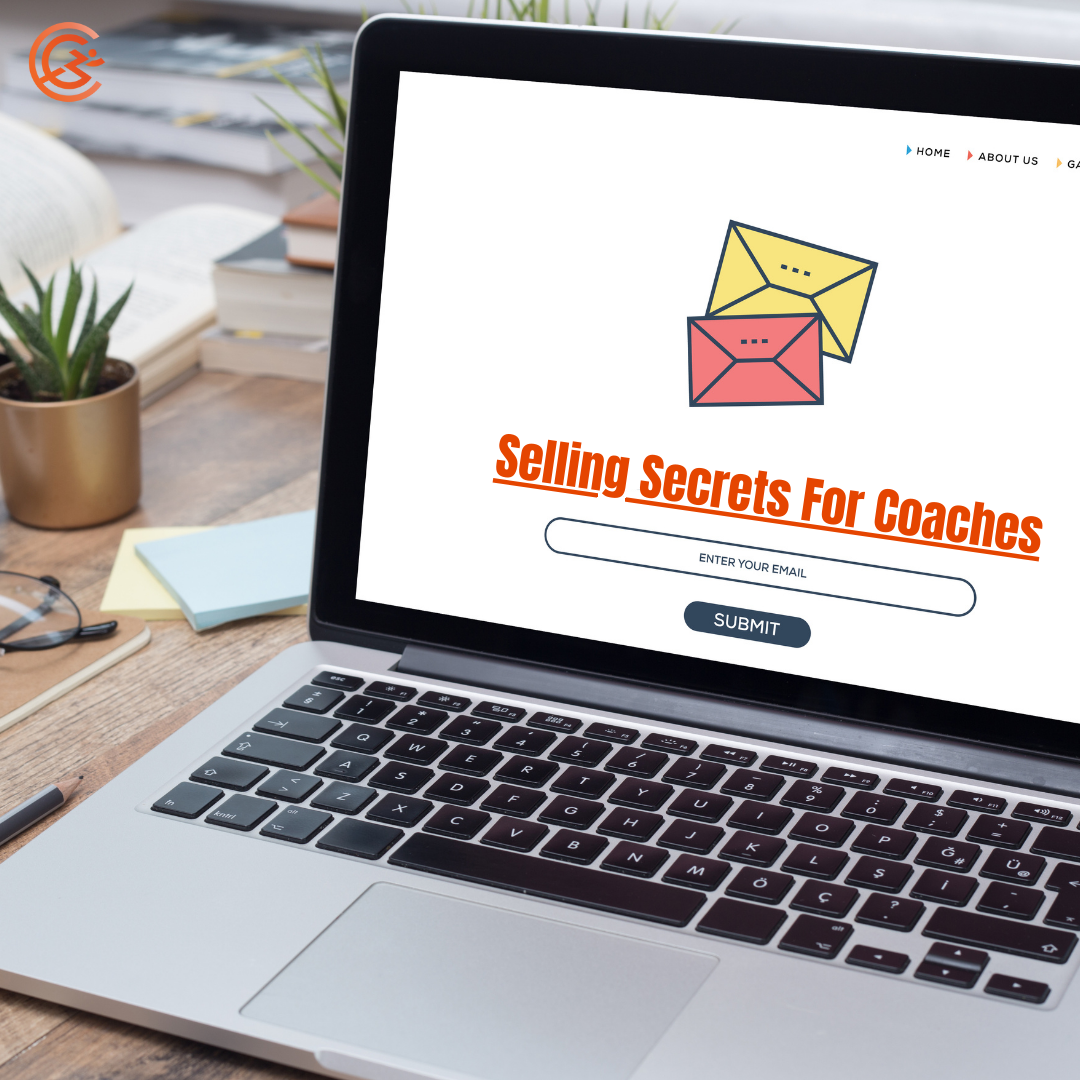 coachnow laptop sitting on a desk with a white screen with a yellow and red envelope that says selling secrets for coaches underneath. a box to enter your email with a submit button. Two post it note pads, glasses, and a small plant are on the desk in the