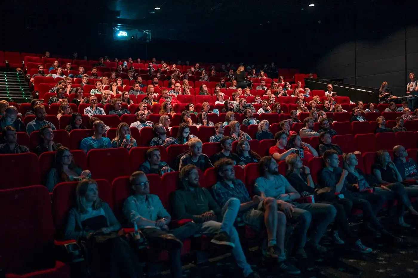 A packed public cinema theater with classic red seats, showing the standard local mall option if you are figuring out where to watch a movie in Bali.