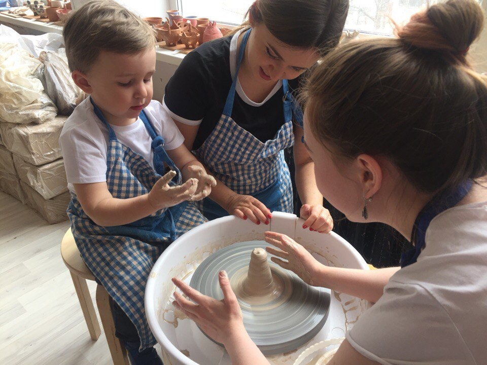 Kids trying the pottery wheel
