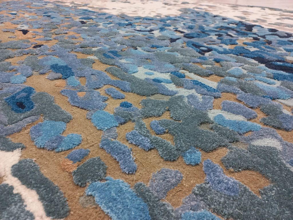 Hand and machine carved multi-level rug texture