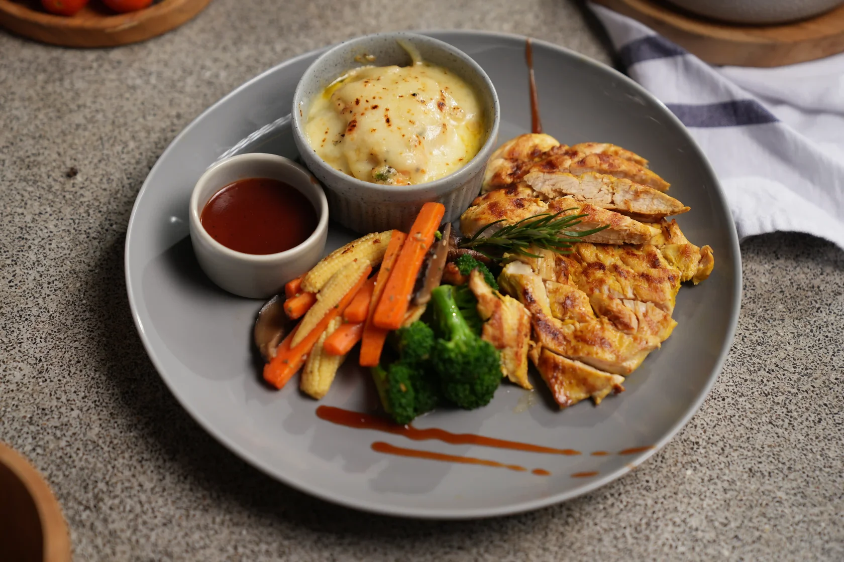 Grilled chicken breast steak served with vegetables, potato and BBQ sauce at Eden Hookah Club Canggu