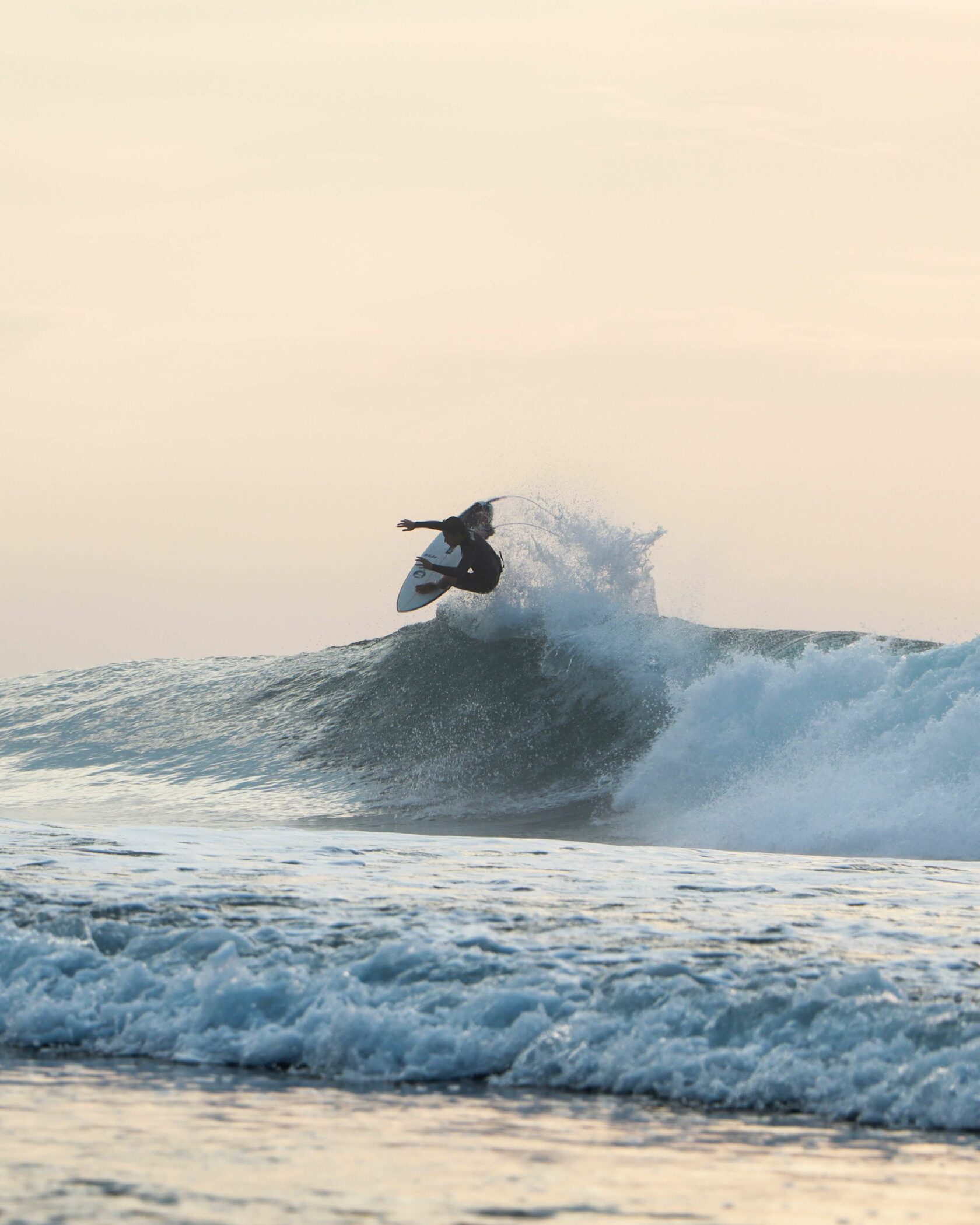 Jumping on the surfboard Bali