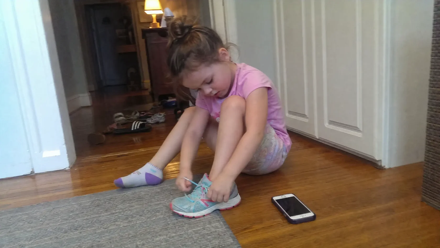 A happy child successfully transitioning from a tablet screen to brushing their teeth in the bathroom.