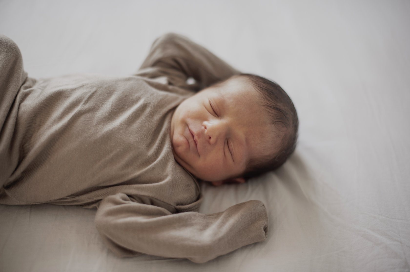 Newborn baby napping during daytime nap routine in a safe sleep environment