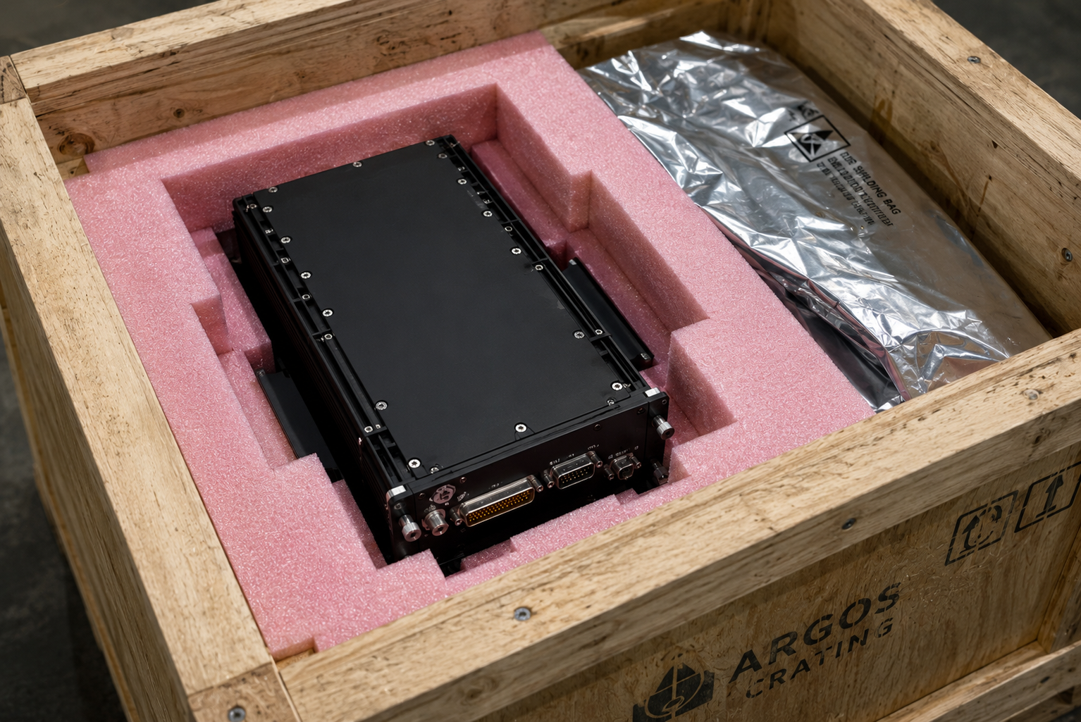 Aircraft avionics component in custom ESD anti-static foam inside a wooden shipping crate — precision packaging for aerospace parts at Argos Crating