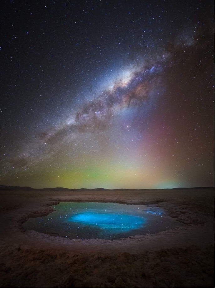 A pool of water in a desert

Description automatically generated