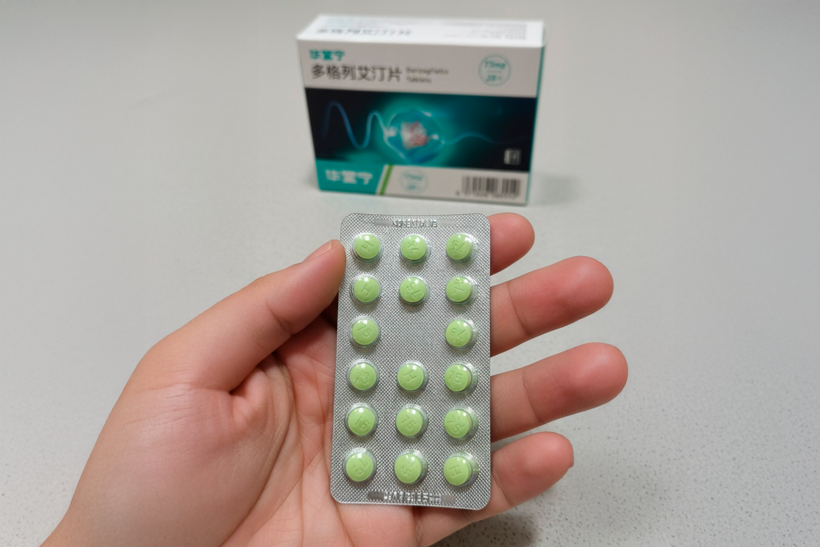 Person holding a blister pack of green Dorzagliatin 75 mg tablets in hand, with the box in the background, used to control blood sugar levels in patients with type 2 diabetes.