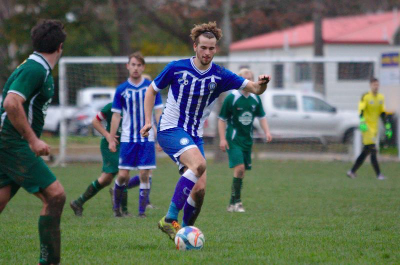 Colin van Gool, replacing Jack Ferris as a centre defender yesterday, dribbling up with the ball.