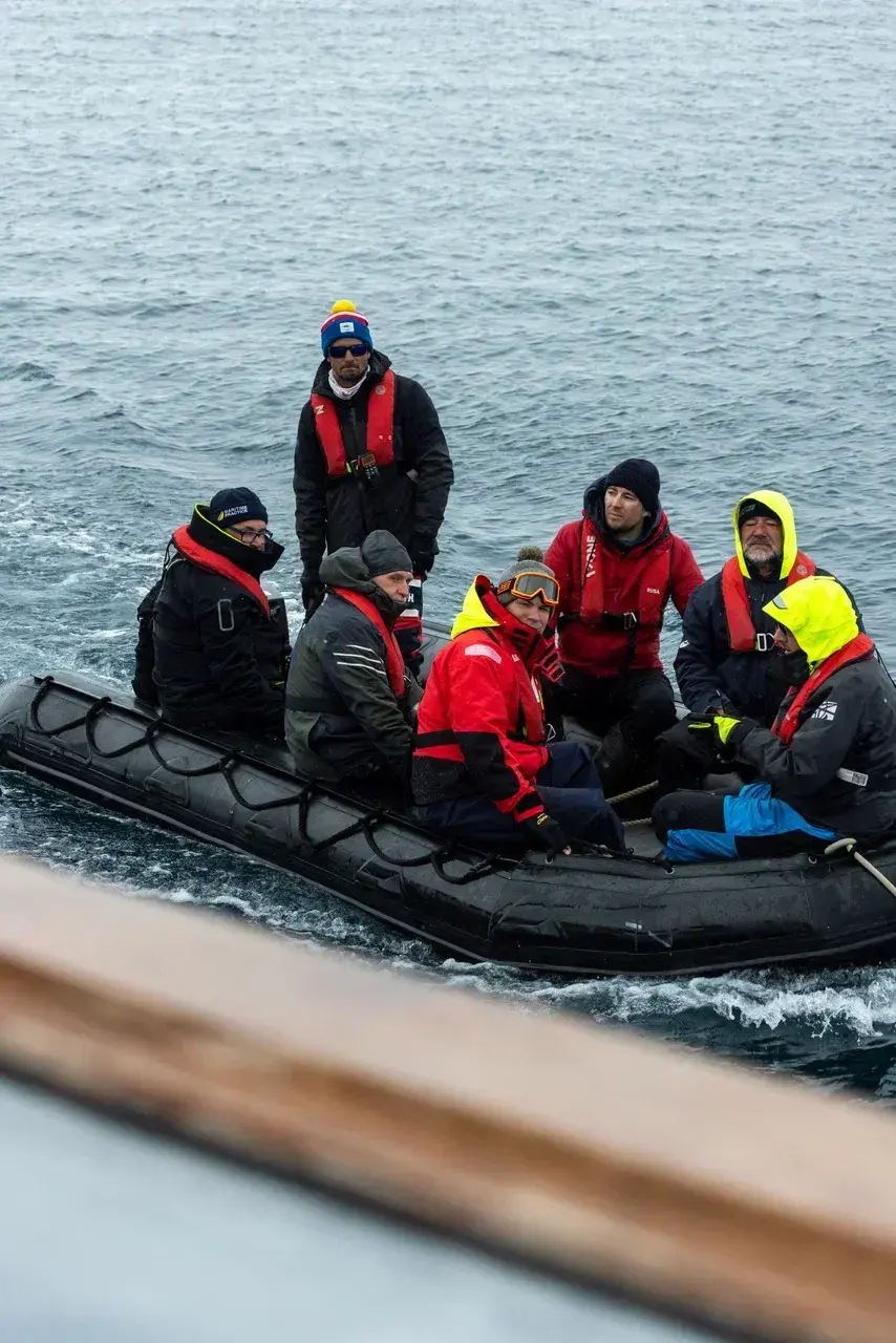 An experienced polar expedition team traveling by Zodiac through remote Antarctic waters. Professional captains sailors and polar guides ensure safe landings expert navigation and unforgettable small-group exploration during MoreTime Expeditions voyages.