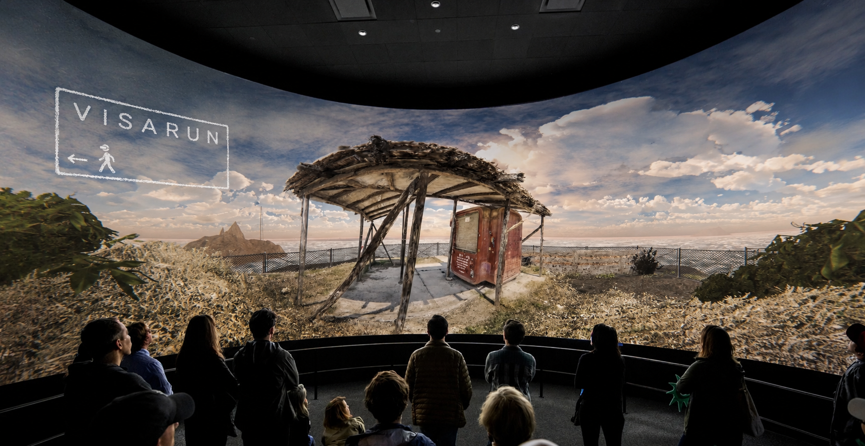 Immersive projection room for VISARUN with viewers facing a panoramic screen