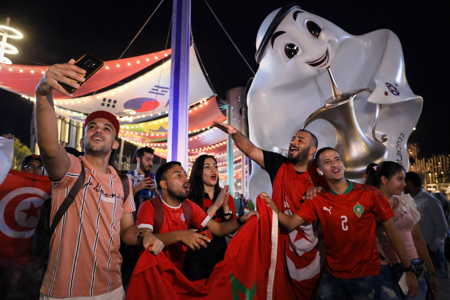 Fans taking photos with large mascot sculpture in sporting event fan zone