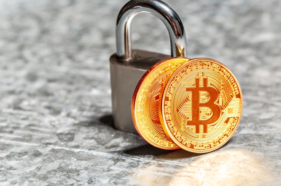 Best VPN for Crypto Trading: A padlock with a golden Bitcoin coin secured through its shackle, symbolizing the encryption of a VPN connection, on a gray-marbled surface