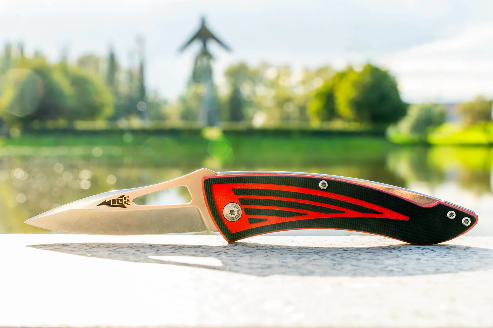 Red-and-black Kizlyar Supreme MiG in the summer landscape