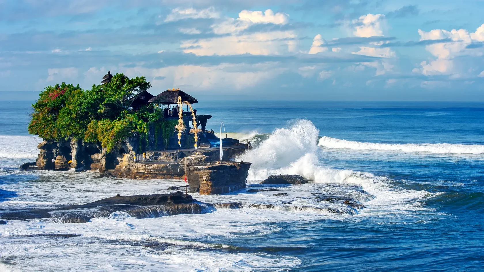 Pura Tanah Lot sea temple on a rock formation, a famous Bali sacred location for sunset views and spiritual worship.