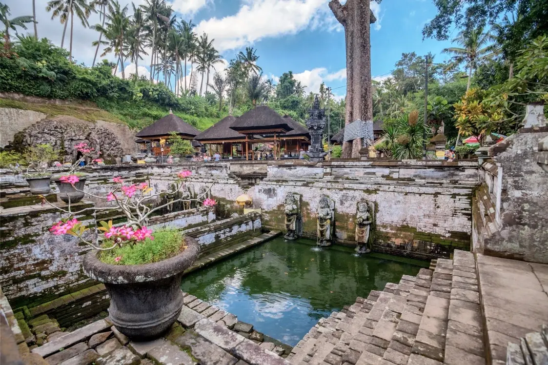 Sacred bathing pools and ancient stone statues surrounded by tropical greenery at Goa Gajah, a historic elephant cave temple in Ubud.