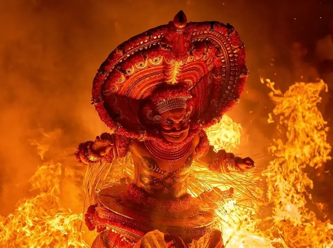 A close-up of a fierce Ogoh Ogoh Bali mask engulfed in flames, representing the symbolic burning and destruction of negative spirits (Bhuta Kala) before Nyepi Day.