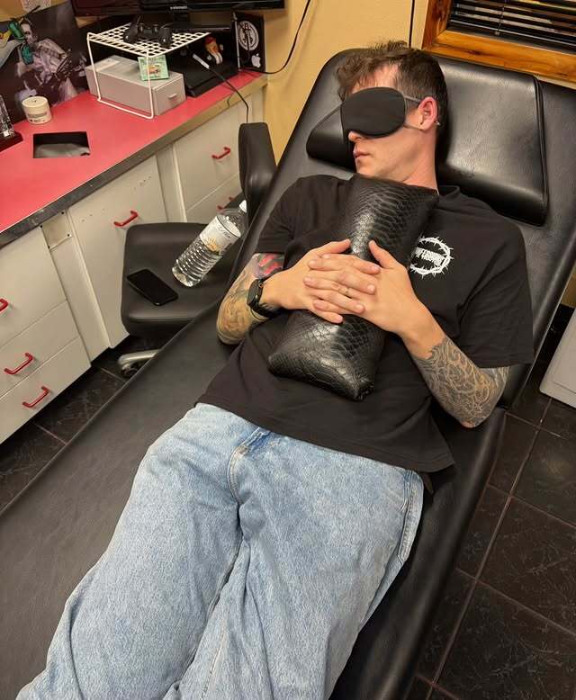 blog, Tattoo artist resting in a tattoo chair with a sleep mask and pillow during a guest spot, 518
