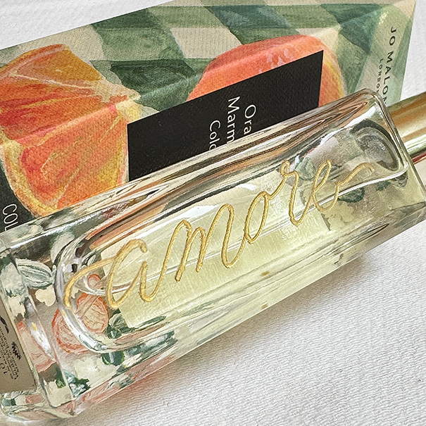 Engraved Jo Malone perfume bottle with gold "Amore" calligraphy script.