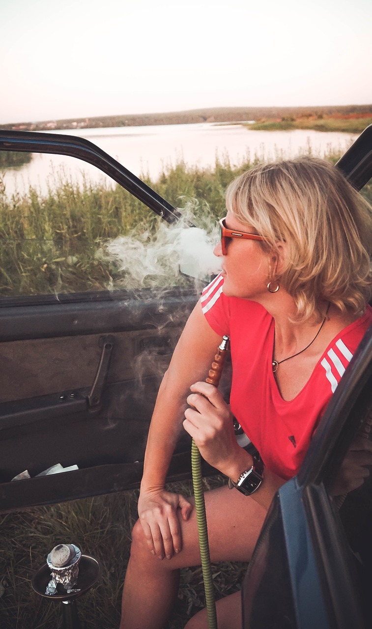 a woman enjoy Hookah in her car