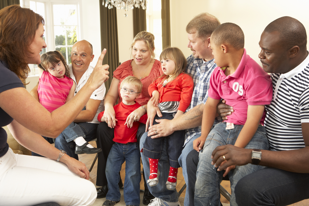 a group of disabled children with their parents at school with their teacher wearing red tshirts