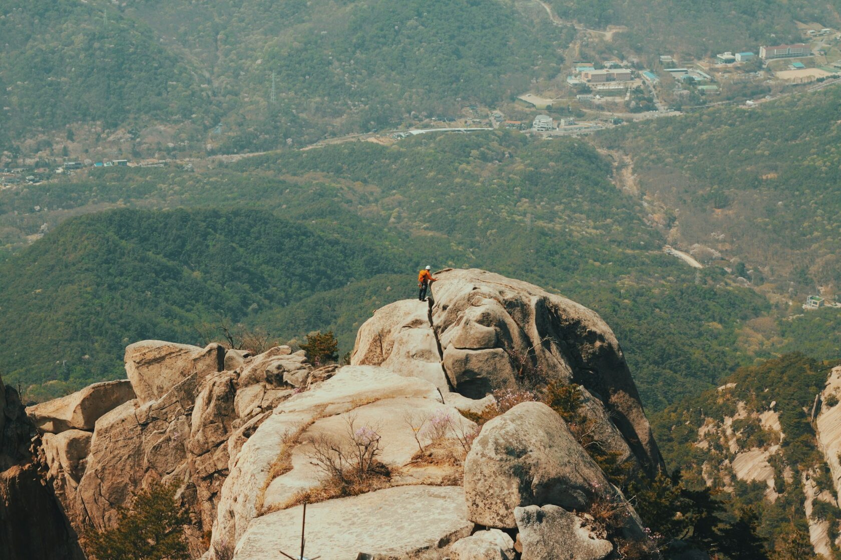 Hiker on a rocky ridge above the treeline