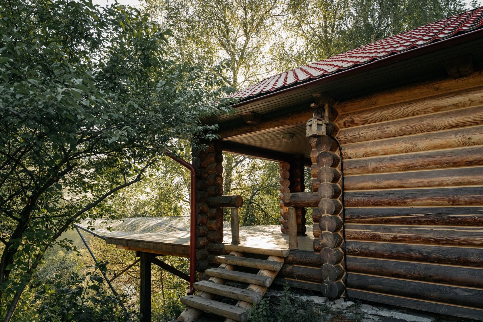 Log cabin wooden porch with tree canopy