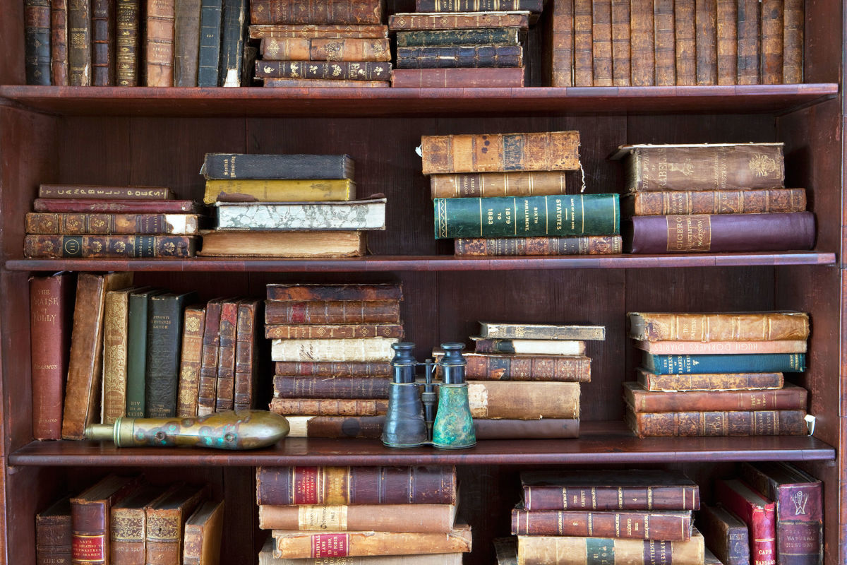 Antique books photos. Black Bookshelf with books. Types of books. Bag Full of Antique books.