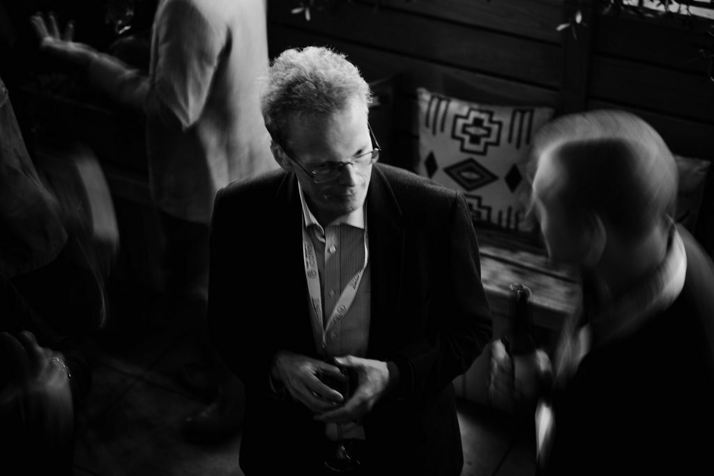 event photo of a man having discussion with a partner