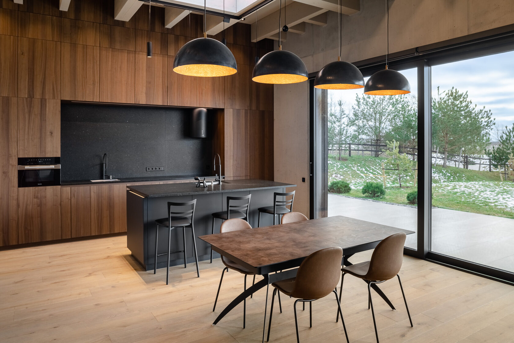 living room connected to kitchen with panomaric windows during the afternoon - winter time