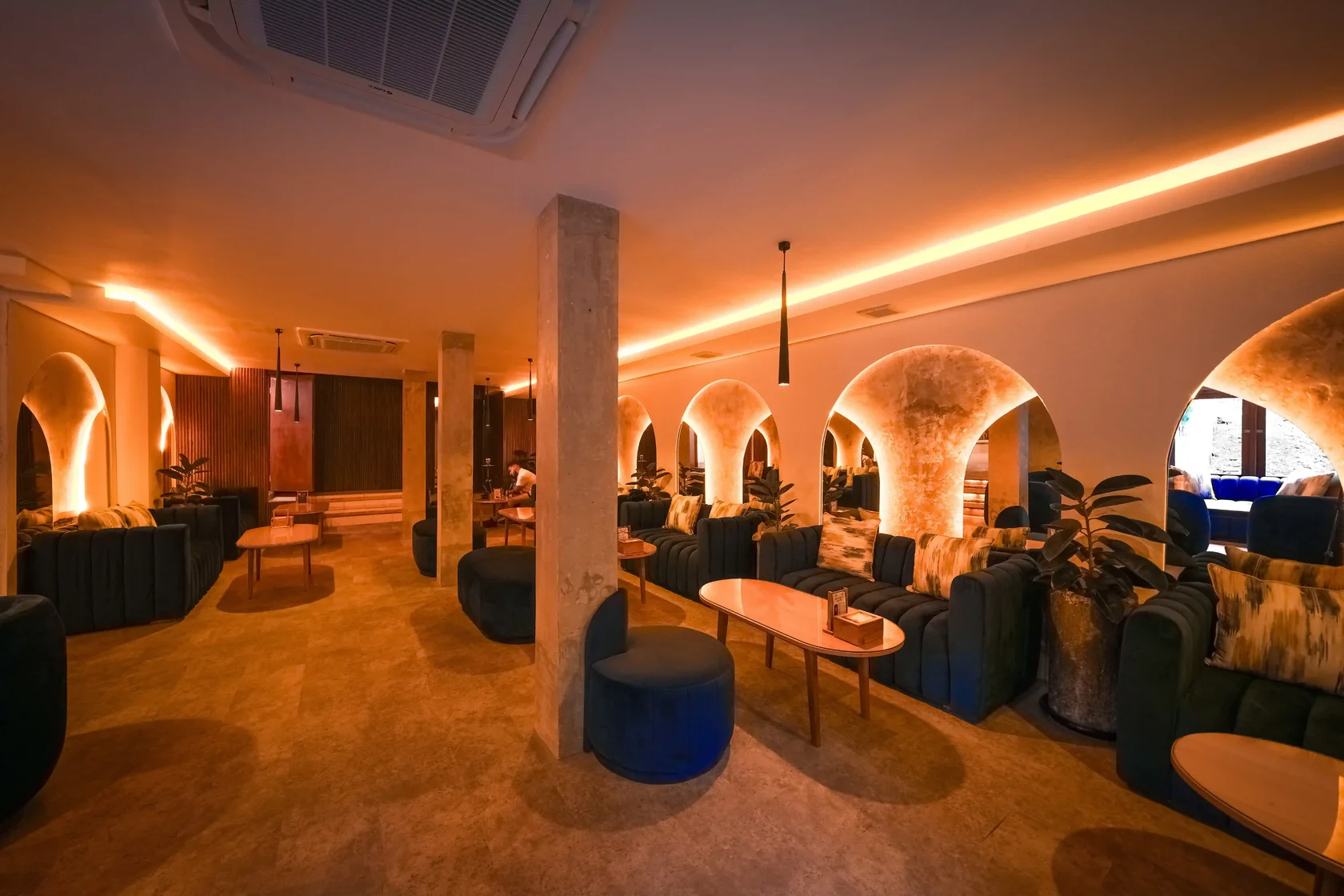 Relaxing ambiance at Eden Lounge Ubud featuring plush blue seating and artistic arches, ideal for reflective evenings and post-Iftar gatherings during Ramadhan in Bali.