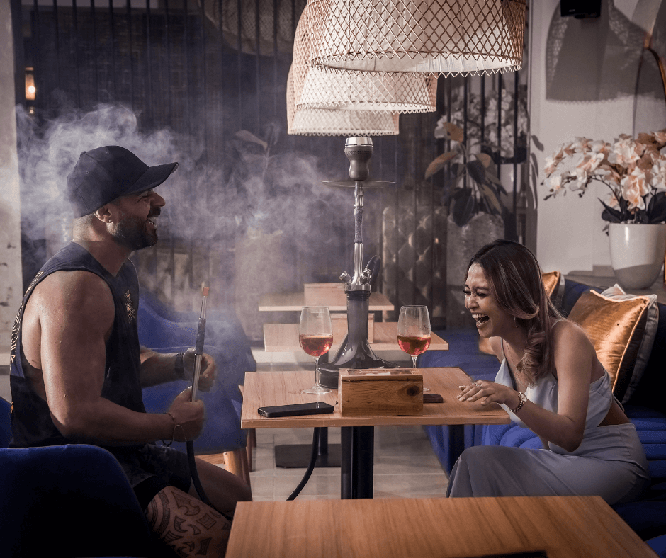 a man with Hookah enjoy the vibes with his woman