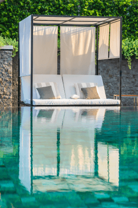 Беседка с диваном стоят на воде