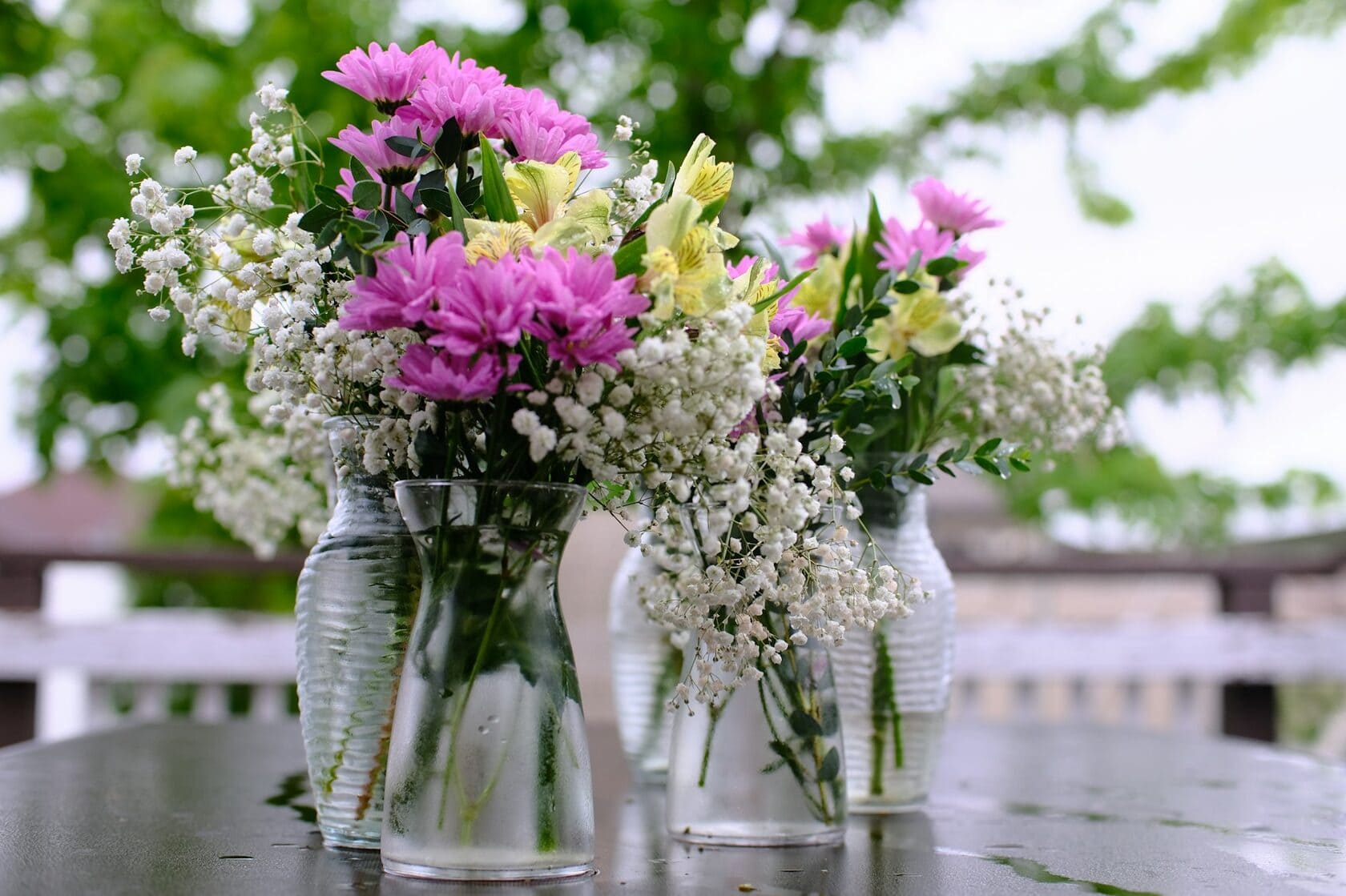 Pastel flower bouquets in glass vases for fresh flower care and home decoration