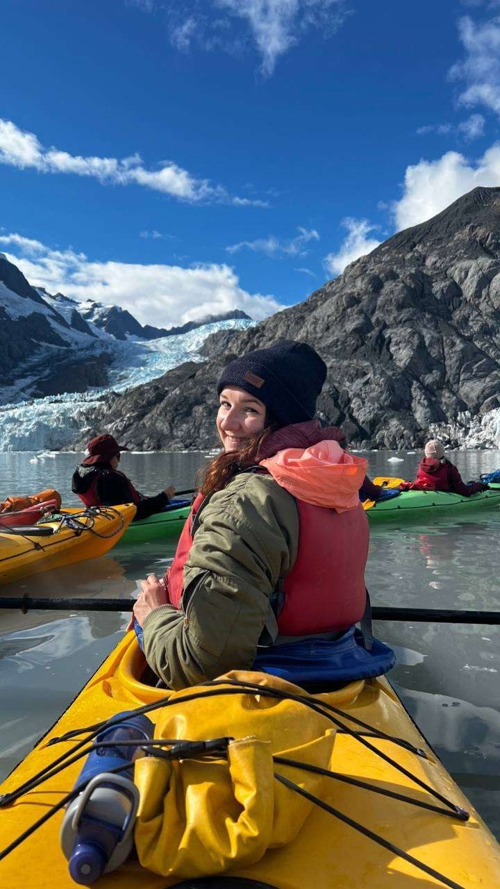 Maria kayaking by a glacier
