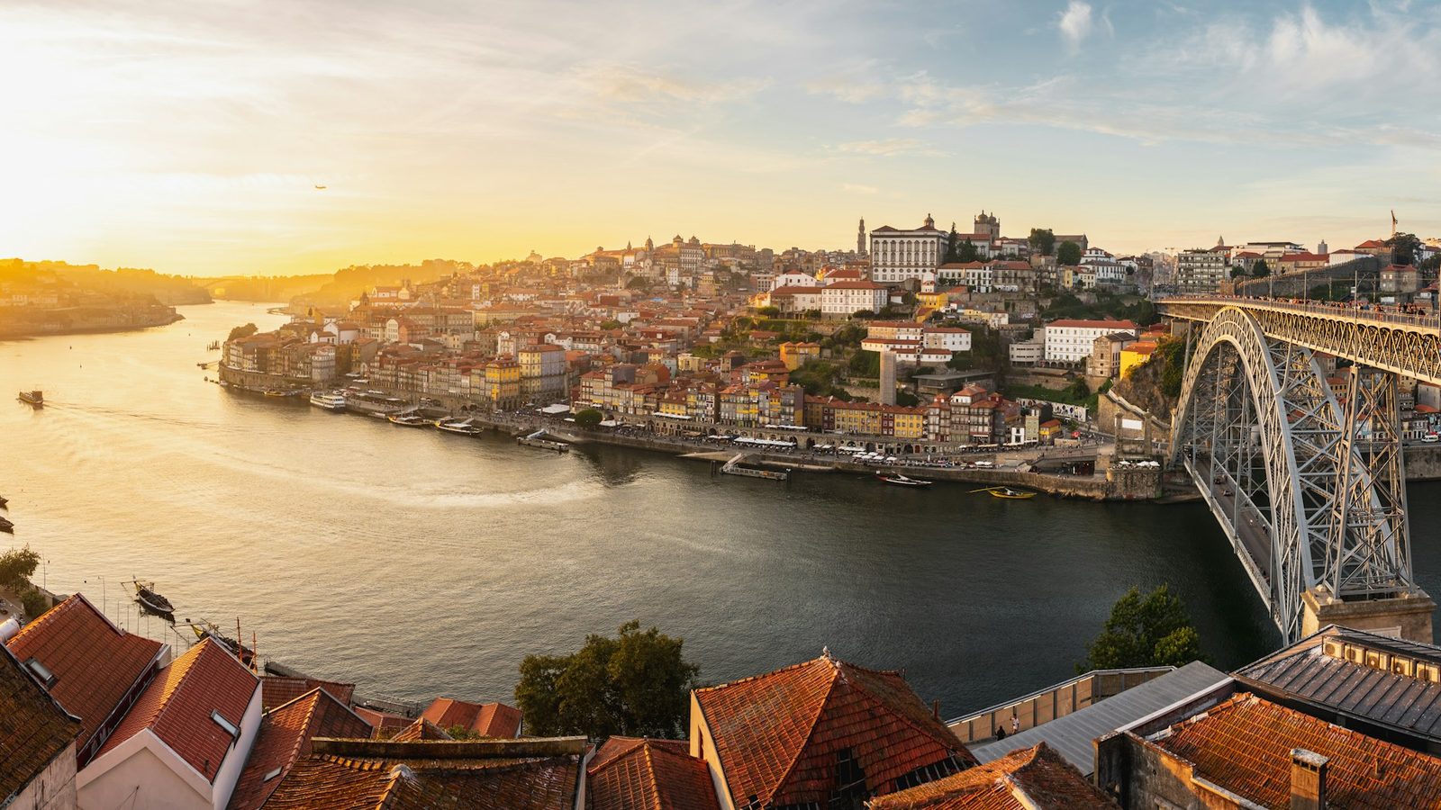 Aerial view of Porto at sunset with the Douro river, the Ribeira riverfront, the old town on the hill and the iron Dom Luís I bridge