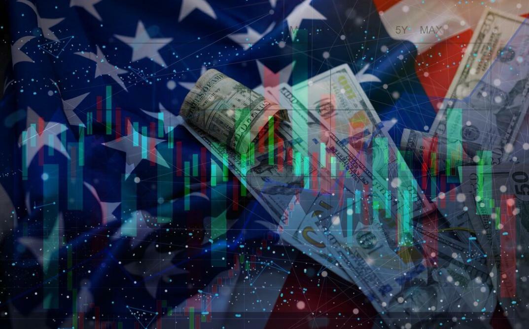 Binance halts customer deposits and withdrawals in the U.S.: Overlaid photographs of the American flag, dollars, and stock charts