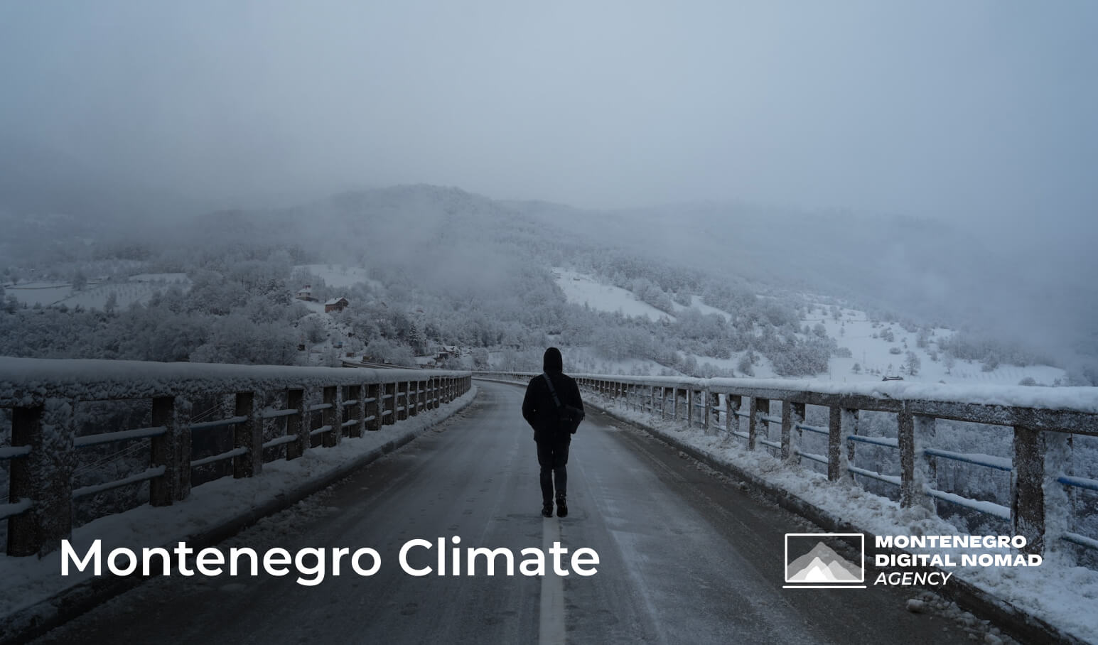Image of a man standing on the Tara Bridge in Montenegro on a snowy winter day
