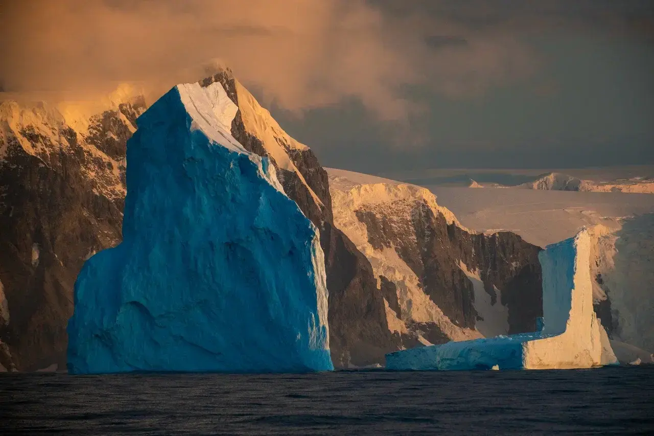 Dramatic icebergs and snow-covered mountains along the Antarctic Peninsula during an Antarctica sailing expedition
