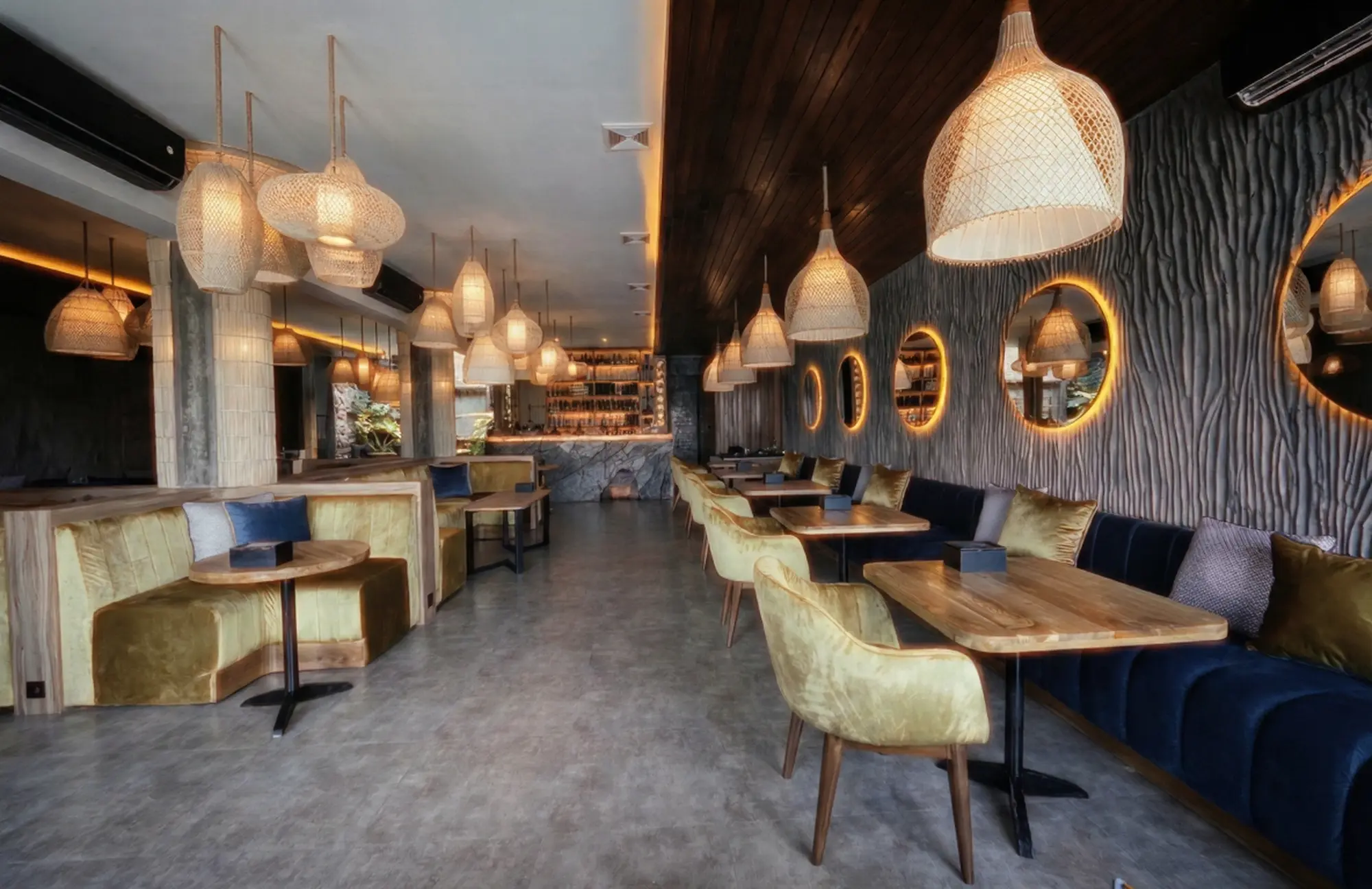 Elegant interior with golden booth seating and textured walls at Eden Lounge Uluwatu, perfect for a premium halal iftar in Bali experience