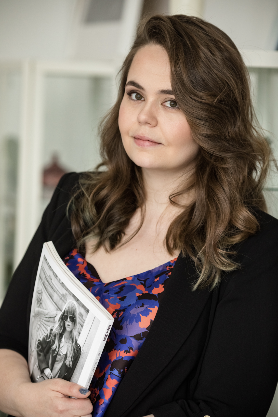 Professional organiser is holding a magazine in her hands