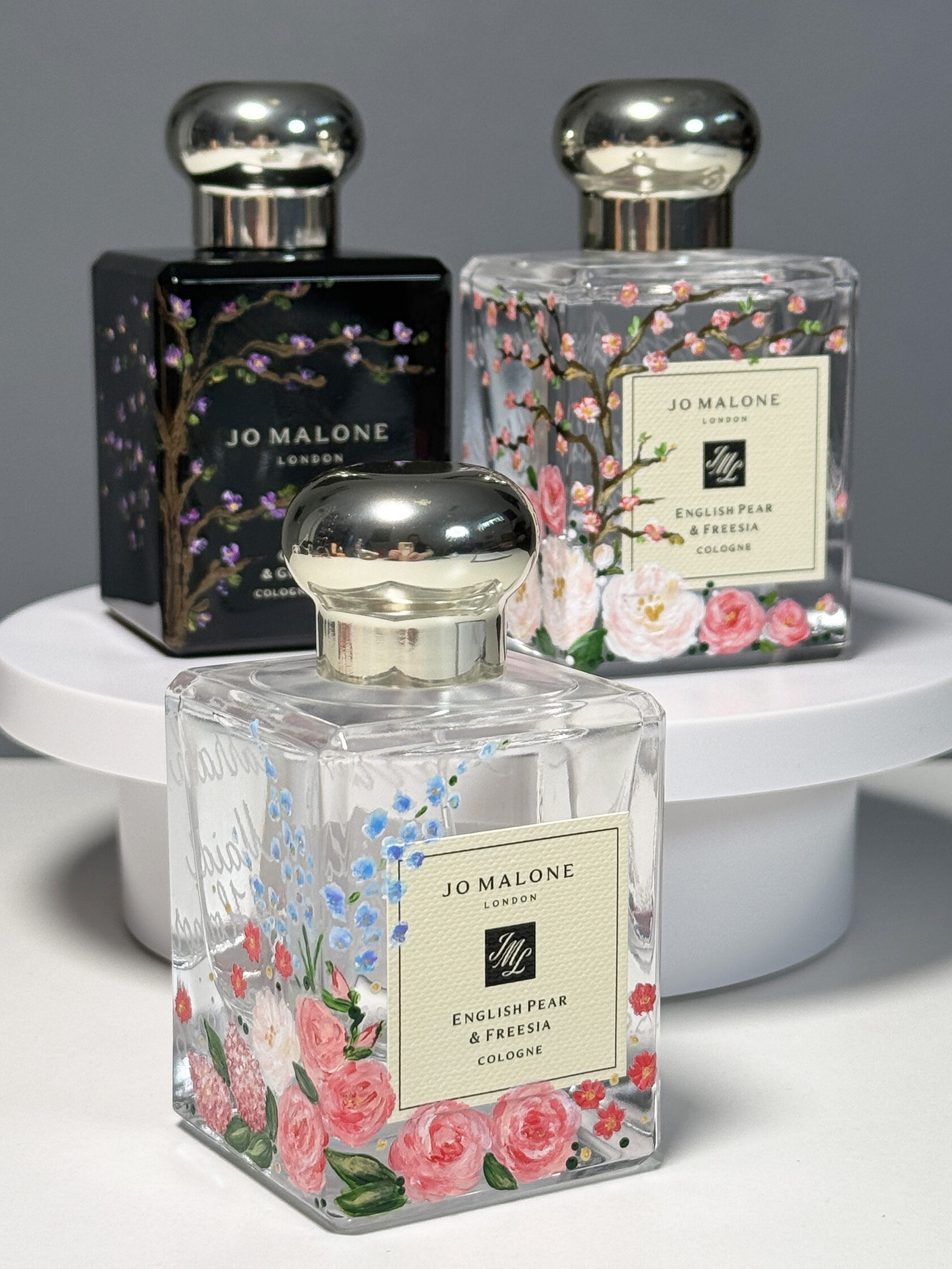 Set of three custom hand-painted and engraved Jo Malone perfume bottles created for a wedding collection by Julia Razz.