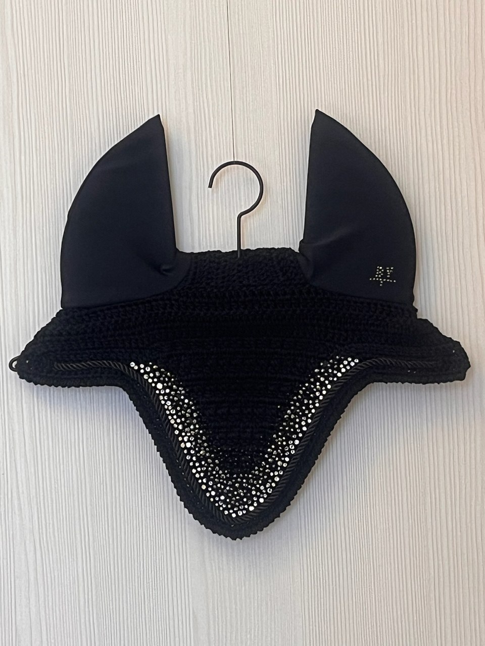 Black wholesale fly bonnet with rhinestones set at an angle.