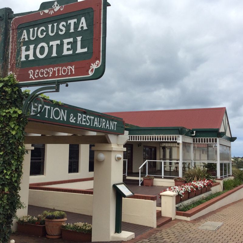 Augusta Hotel – historic accommodation and restaurant in Augusta, Western Australia, featuring classic red roof, green trim, and welcoming reception entrance