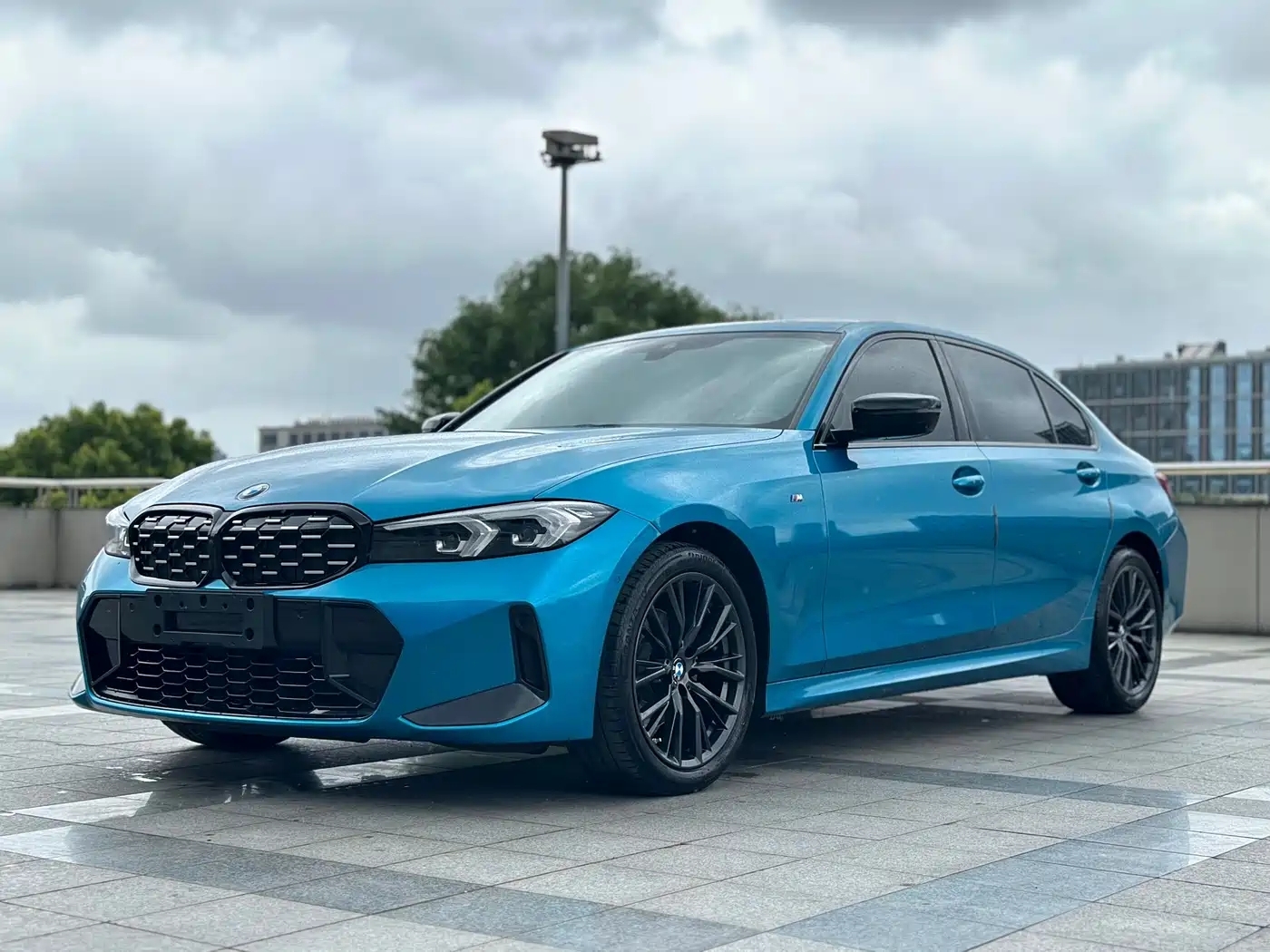 BMW 325Li G28 2023 M Sport Night Package — передняя часть синего седана, ракурс в три четверти
